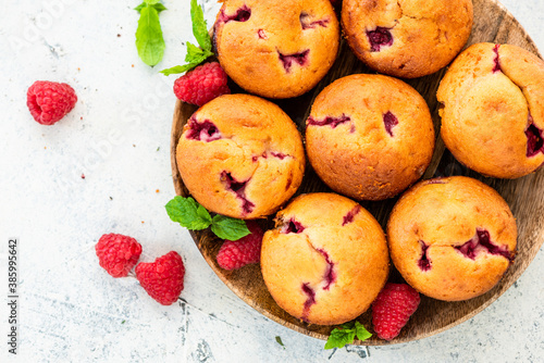 Homemade Raspberry Muffins on Wooden Plate