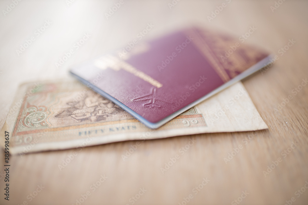 Fifty Burmese Kyats Bill Partially Inside a Sweden Passport Fifty Burmese Kyats Bill Partially Inside a Sweden Passport