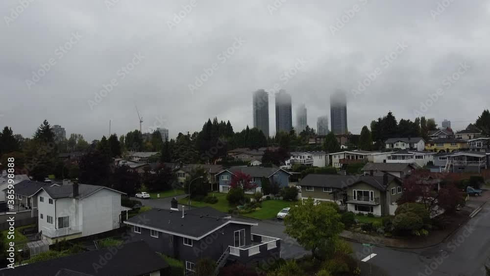 Opening shot of skyscrapes in the clouds with small houses in front Opening shot of skyscrapes in the clouds with small houses in front