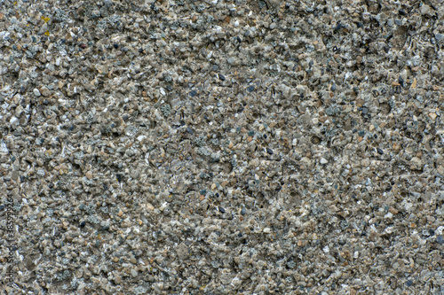 Gray background with a uniform pattern. Fine stone surface. Stone texture. Selective focus.