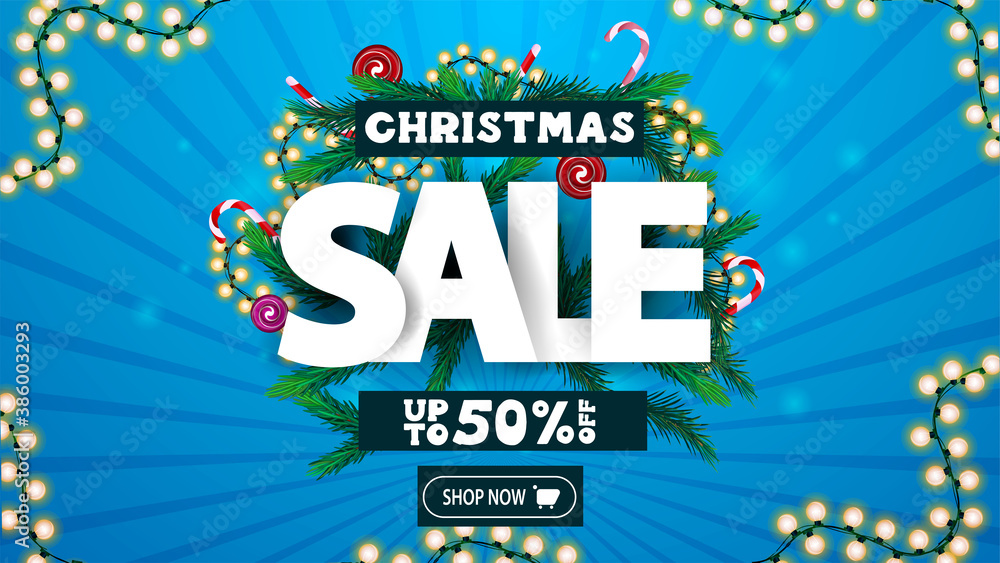 Christmas sale, up to 50% off, discount banner with volumetric text decorated of Christmas tree branches, candys and garlands.