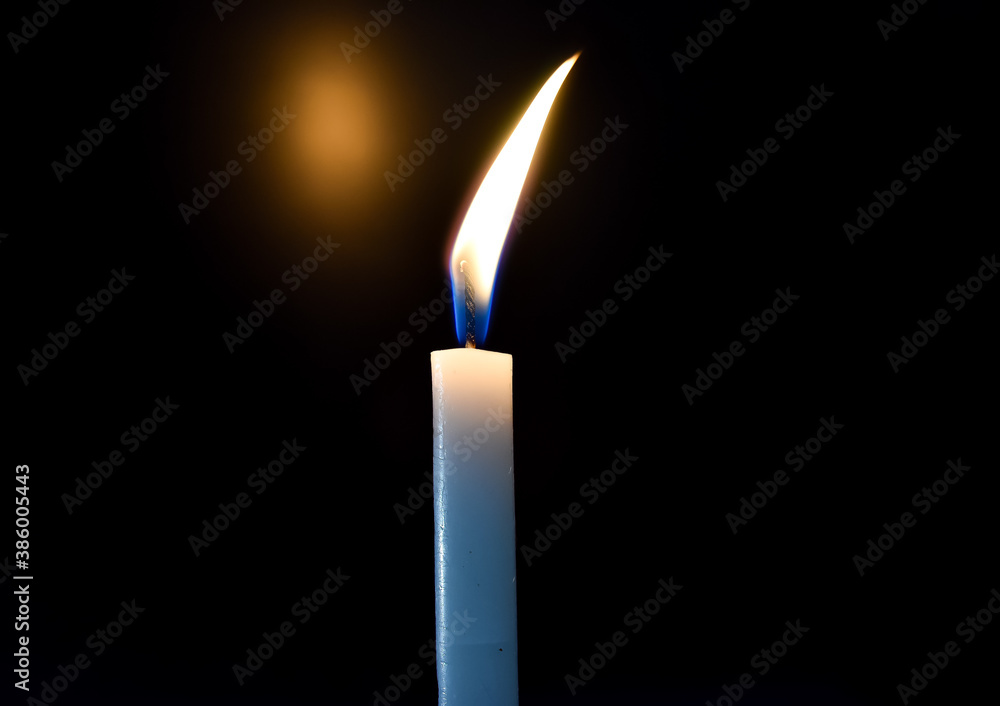 burning candle on black background burning candle on black background