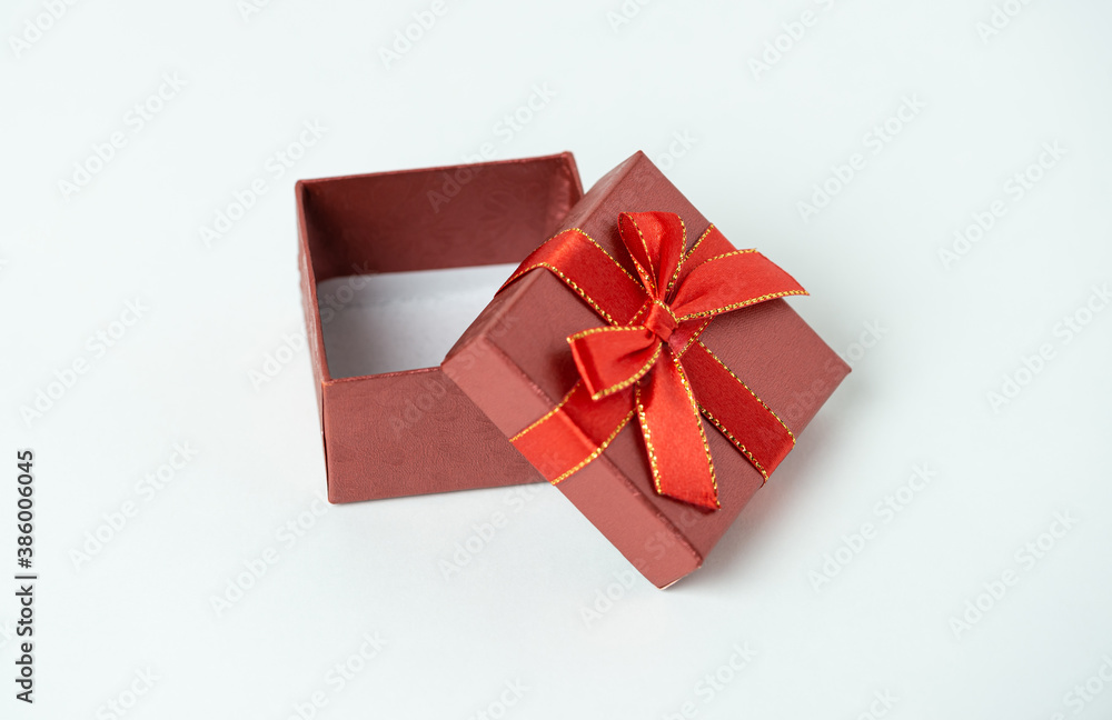 Red gift box with ribbon and bow on white background. For new year, Christmas, Valentine's day and other holiday compositions Red gift box with ribbon and bow on white background. For new year, Christmas, Valentine's day and other holiday compositions