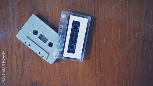 Close-up images of cassette tape on retro wood table. represent nostalgia mood