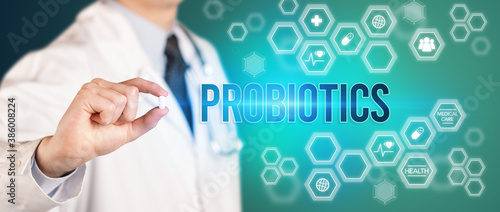 Close-up of a doctor giving you a pill with PROBIOTICS inscription, medical concept