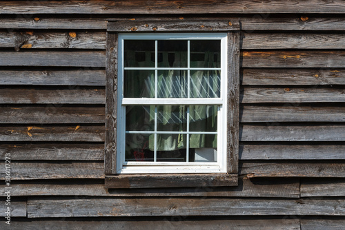 Old wooden window on a wooden facade