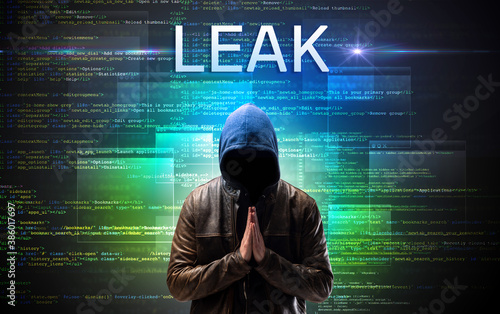 Fototapeta Naklejka Na Ścianę i Meble -  Faceless hacker with LEAK inscription on a binary code background