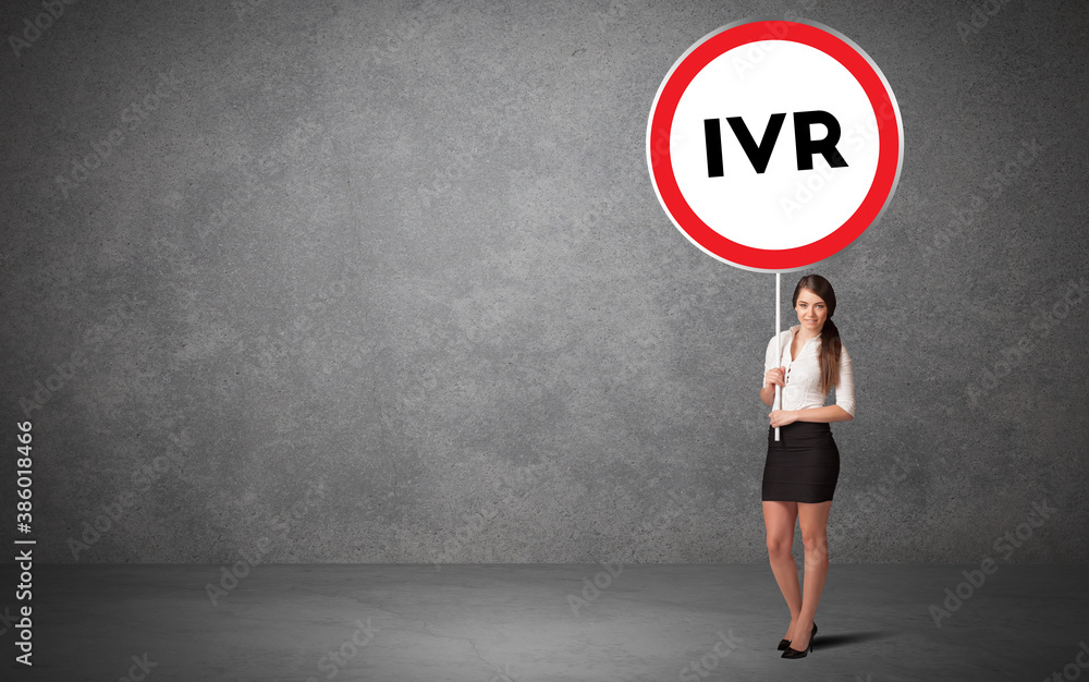 Young business person holdig traffic sign with IVR abbreviation, technology solution concept Young business person holdig traffic sign with IVR abbreviation, technology solution concept