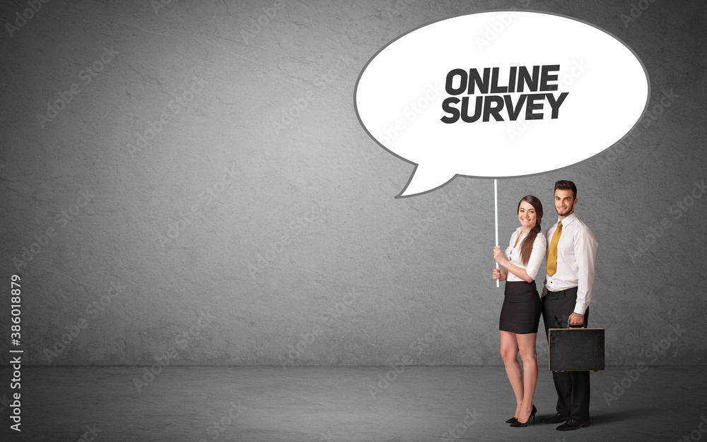 Young business person in casual holding road sign with ONLINE SURVEY inscription, new business idea concept Young business person in casual holding road sign with ONLINE SURVEY inscription, new business idea concept