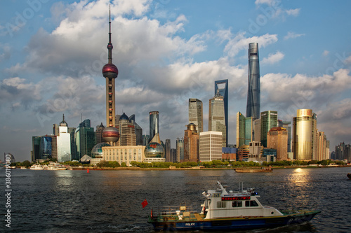 Shanghai Pudong Skyline at Yangtze in late afternoon light with Police boat