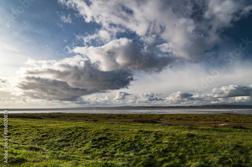 An autumnal image of a weather front over Morecambe bay, stretching from Bolton Le Sands to Walney Island, Lancashire, England photo