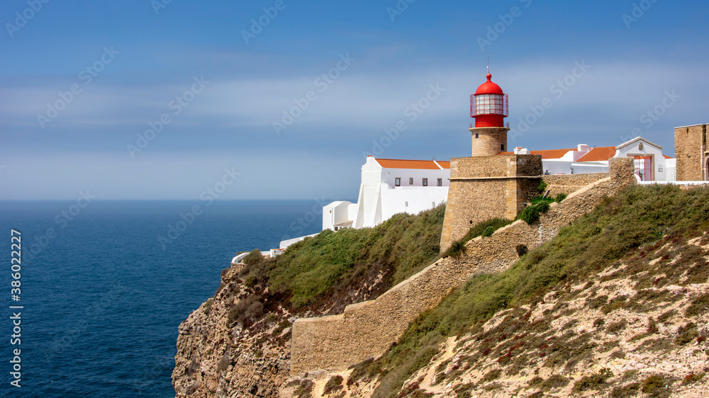 Red lighthouse overlooking the sea at Cabo San Vicente in Sagres, Portuguese Algarve