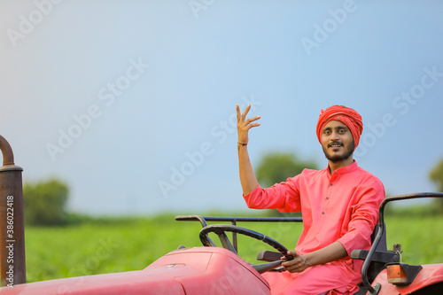 Indian farmer working with tractor at field