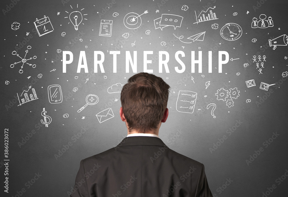Rear view of a businessman with PARTNERSHIP inscription, modern business concept Rear view of a businessman with PARTNERSHIP inscription, modern business concept