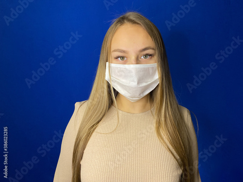 A girl in a medical mask protects herself from the COVID-19 virus