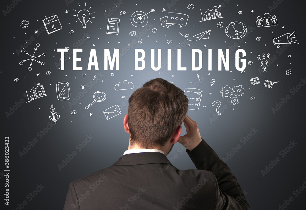Rear view of a businessman with TEAM BUILDING inscription, modern business concept