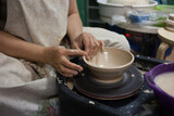 The process of creating pottery on a potter's wheel