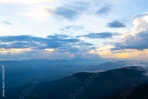 beautiful dark blue mountain landscape with fog and forest. sunrise and sunset in mountains.
