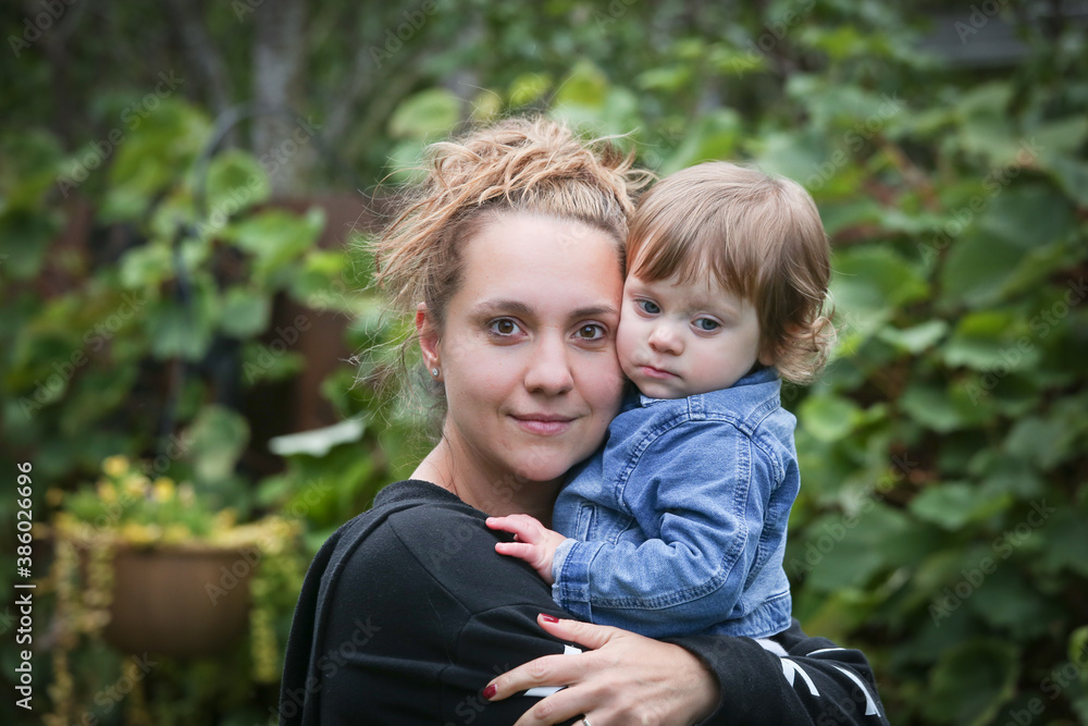 Happy Young Mother Hugs her Little 18 moth Old Baby Girl, Daughter, Happy Family Concept 