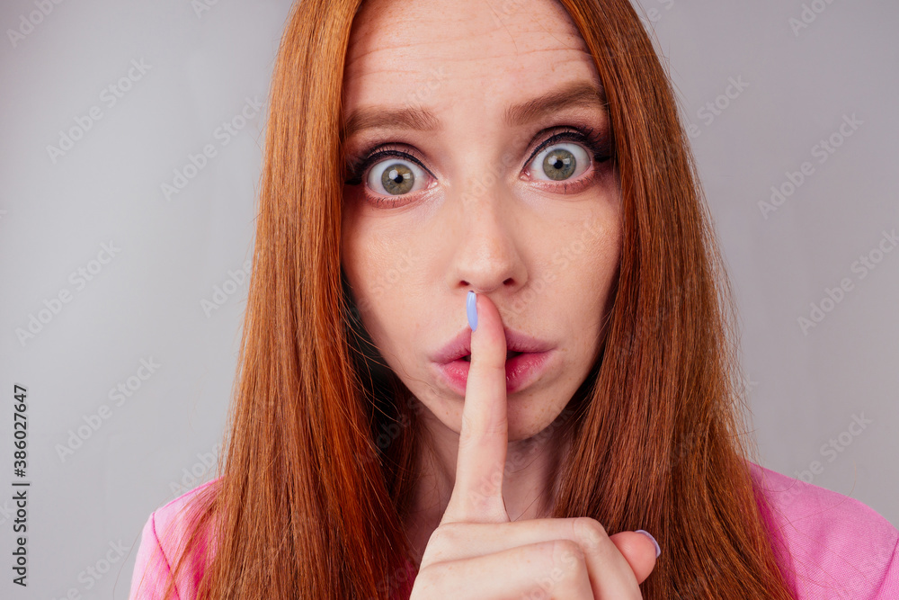 attractive redhair ginger woman can't keep secrets studio background attractive redhair ginger woman can't keep secrets studio background