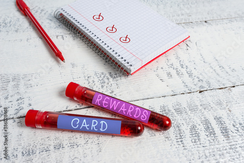 Handwriting text Rewards Card. Conceptual photo Help earn cash points miles from everyday purchase Incentives Extracted blood sample vial with medical accessories ready for examination photo