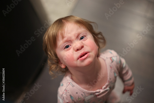 Close up Portrait of cute 18 month Old Crying Toddler Girl with Big Blue Eyes