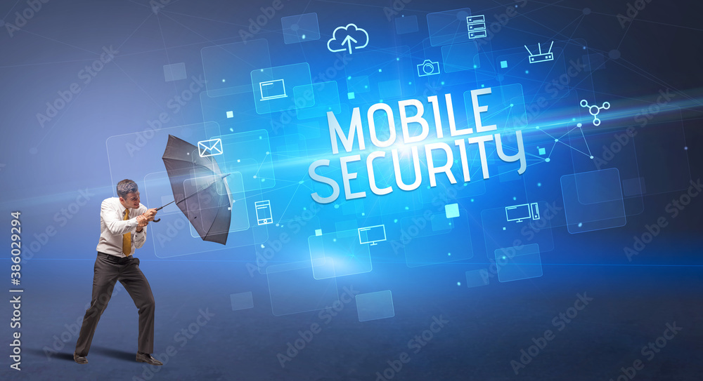 Businessman defending with umbrella from cyber attack and MOBILE SECURITY inscription, online security concept Businessman defending with umbrella from cyber attack and MOBILE SECURITY inscription, online security concept