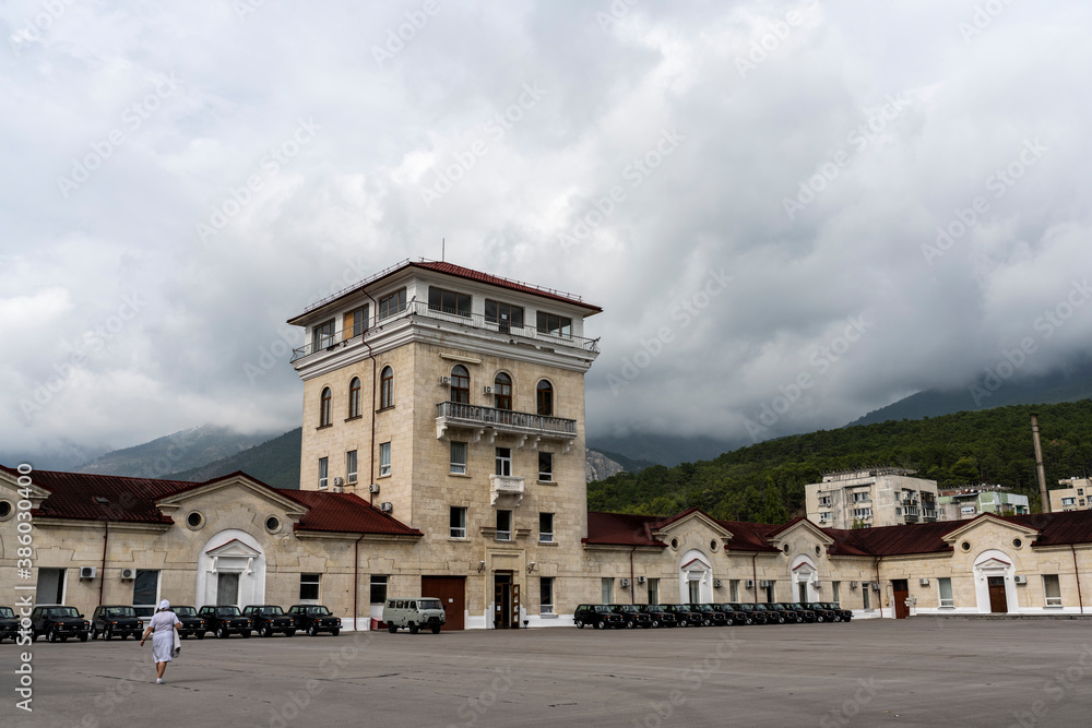 large square in front of the winery against the backdrop of mountains and storm clouds