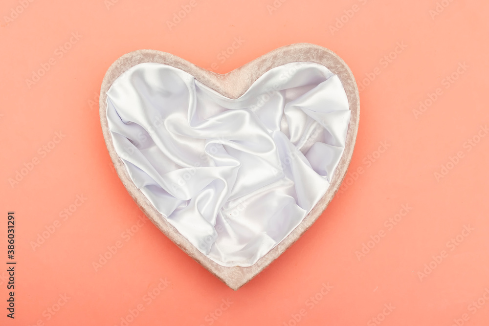 textile heart shape gift box on pink background 