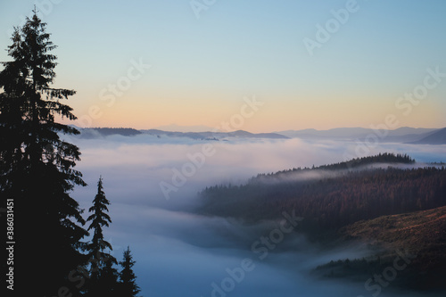 Over the clouds view, mountains in the background, sunrise © Stefana