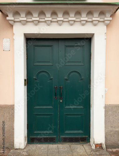 Emerald green old door in a light house