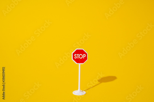 stop sign on yellow background, minimal road sign concept. photo