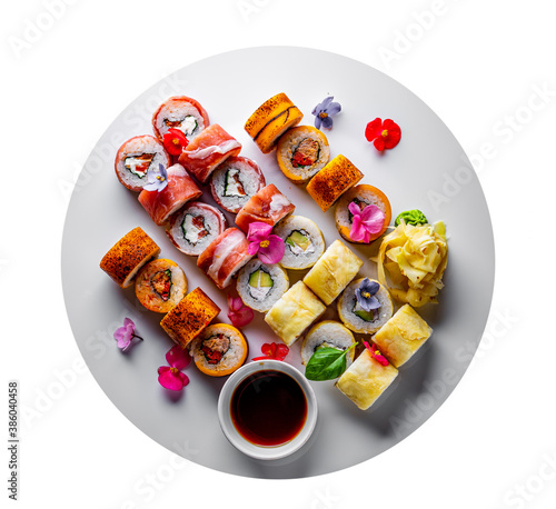 set of sushi roll with salmon, avocado, cream cheese, cucumber, rice, caviar, eel, tuna in plate isolated on white background