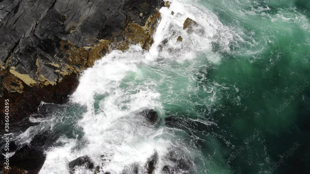 aerial view of ocean waves crashing up on the rocks on Monhegan Island Maine