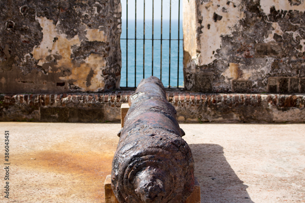 A historic and rustic canon pointing out to sea in San Juan Puerto Rico