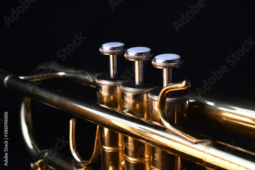 Brass instruments, golden trumpet in the dark photo