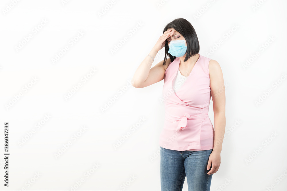 woman wearing mask in studio and headache expression woman wearing mask in studio and headache expression