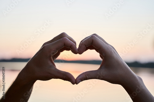Couple in love gesturing heart