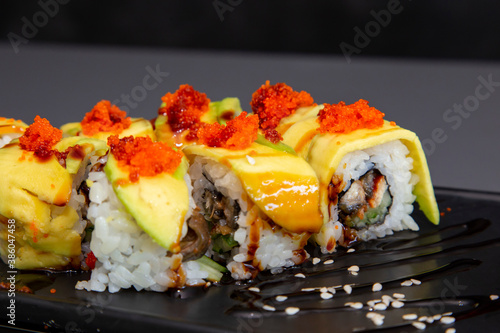 japanese sushi food. Maki ands rolls with tuna, salmon, shrimp, crab and avocado. Top view of assorted sushi. Rainbow sushi roll, uramaki, hosomaki and nigiri. Assorted sushi