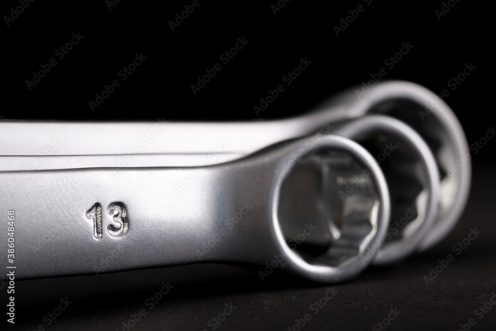 Metal flat keys on a dark table. Accessories for mechanics and builders. Metal flat keys on a dark table. Accessories for mechanics and builders.