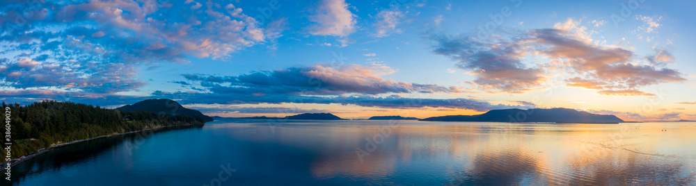 Sunset Over Orcas Island in the Salish Sea and the San Juan Island Archipelago. Beautiful and dramatic sunset with colorful clouds and a calm sea in the Pacific Northwest.