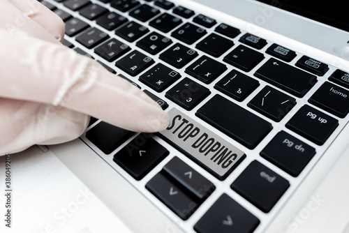 Conceptual hand writing showing Stop Doping. Concept meaning quit the use of banned athletic performanceenhancing drugs Colored PC keyboard key With Accessories on Empty background photo