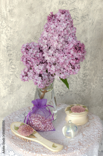 a branch of lilac on the dressing table