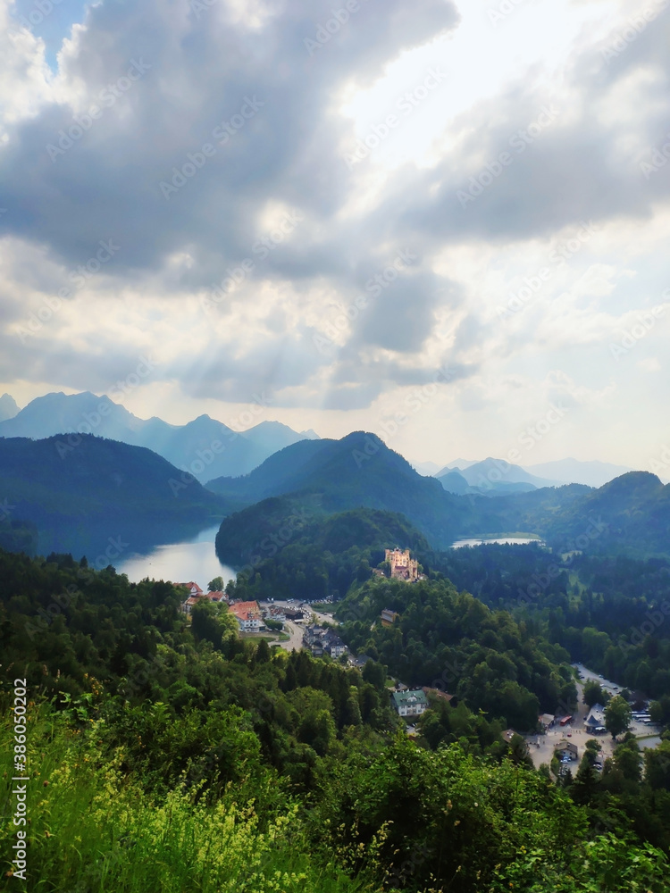 Misty day in the Bavarian Alps near Fussen, Germany. Alps and lakes in a summer day in Germany. Taken from the hill next to Neuschwanstein castle. View of the Hohenschwangau castle, Bavarian Alps