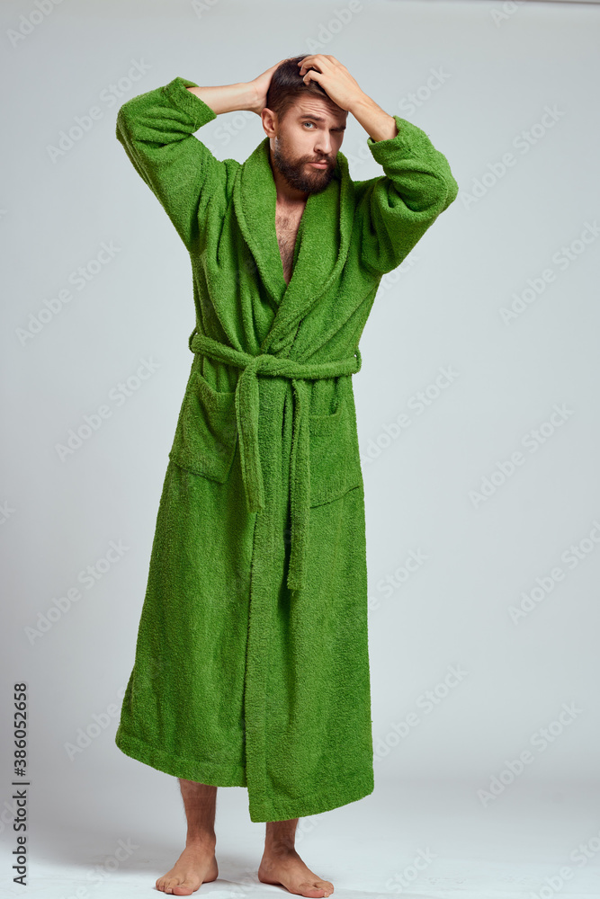 emotional man in a green robe on a light background in full growth fun emotions model emotional man in a green robe on a light background in full growth fun emotions model