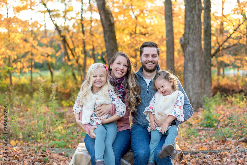 Happy young family at the park in autumn