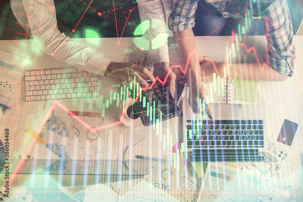 Double exposure of man and woman working together and financial graph hologram drawing. market analysis concept. Computer background. Top View. Double exposure of man and woman working together and financial graph hologram drawing. market analysis concept. Computer background. Top View.