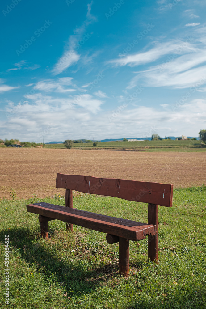 Wooden fence on a green field meadow rural landscape under a blue sunny sky