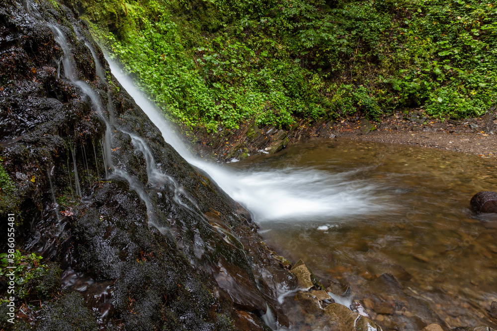 Wonderful waterfall on the mountain river Carpathians. Sopit Waterfall, National Park of Skole Beskydy, Ukraine. Carpathian river, fast current, crystal water. Long exposure shot. Wonderful waterfall on the mountain river Carpathians. Sopit Waterfall, National Park of Skole Beskydy, Ukraine. Carpathian river, fast current, crystal water. Long exposure shot.