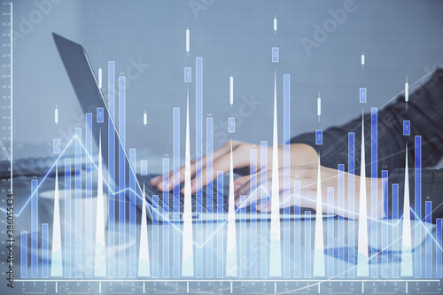 Double exposure of businesswoman hands typing on computer and forex graph hologram drawing. Financial analysis concept. © peshkova